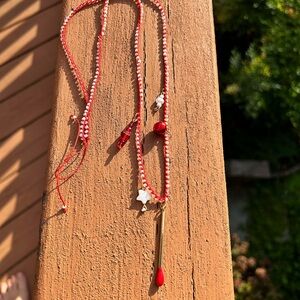 Red read size matches golden design stars on a red silk thread necklace